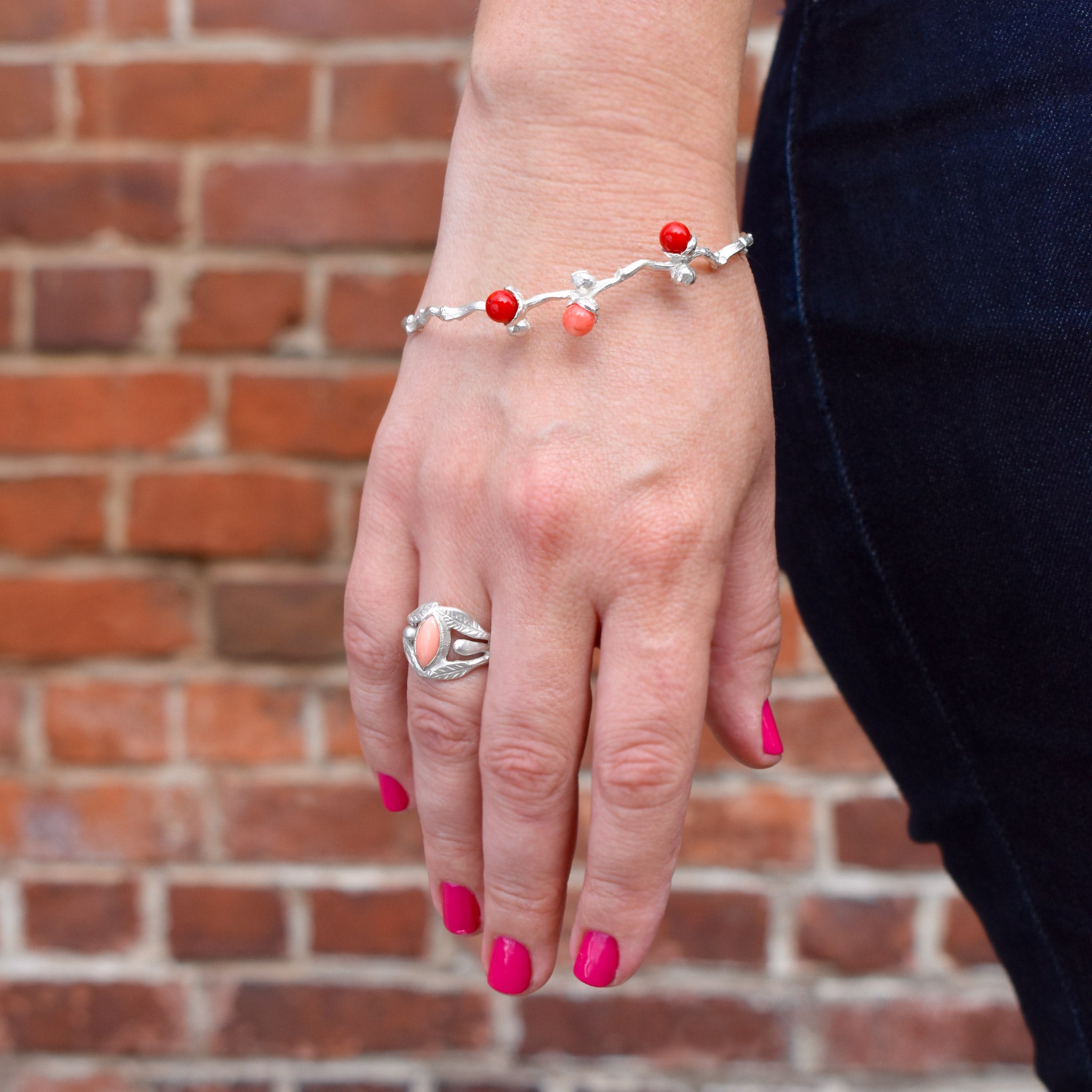 the silver coral beads bangle on a dates' branch
