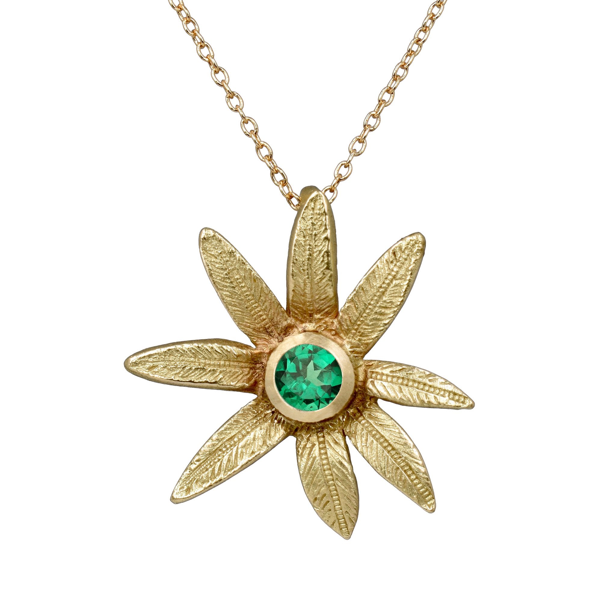 le pendentif fleur en or 18 carats avec une pierre précieuse tsavorite