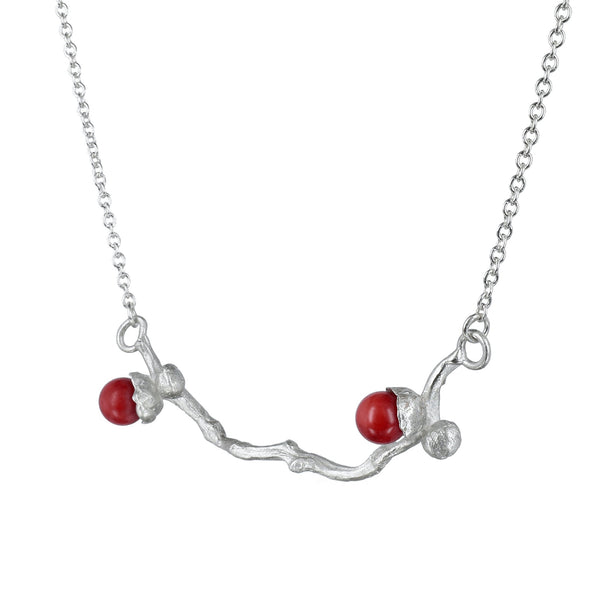 the silver coral bead necklace on a dates' branch
