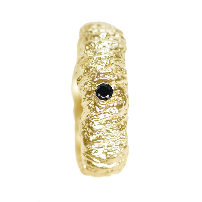 The tree trunk inprint wedding band in 14k and 18k white and yellow gold with a black diamond
