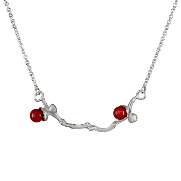 the silver coral bead necklace on a dates' branch