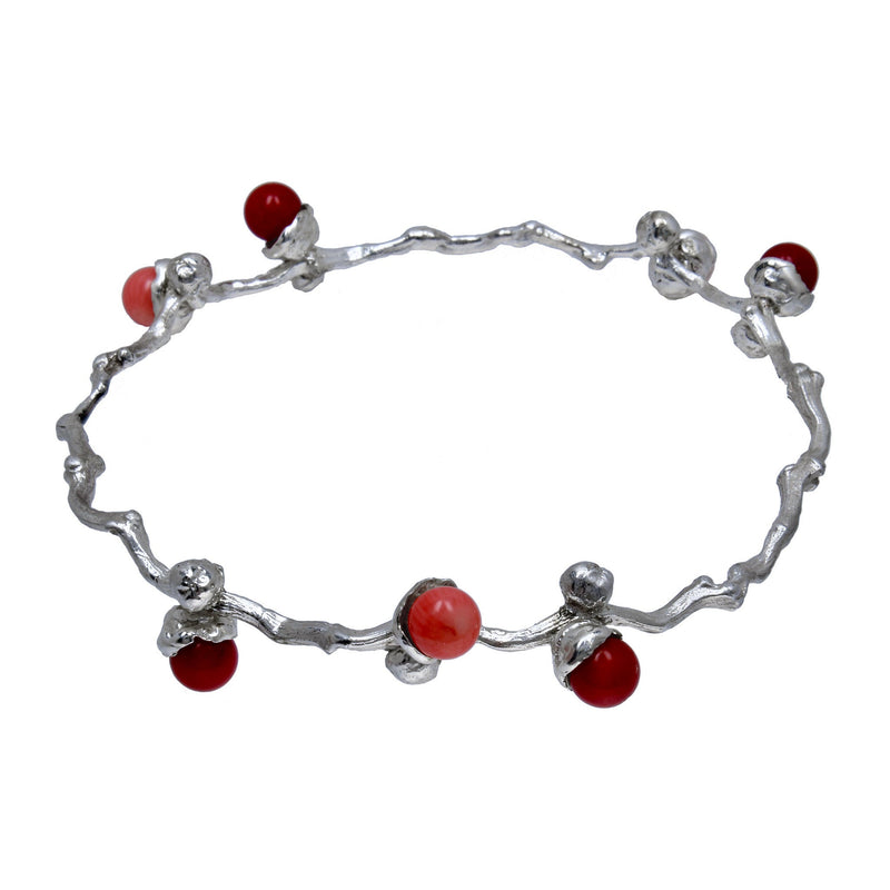 the silver coral beads bangle on a dates' branch